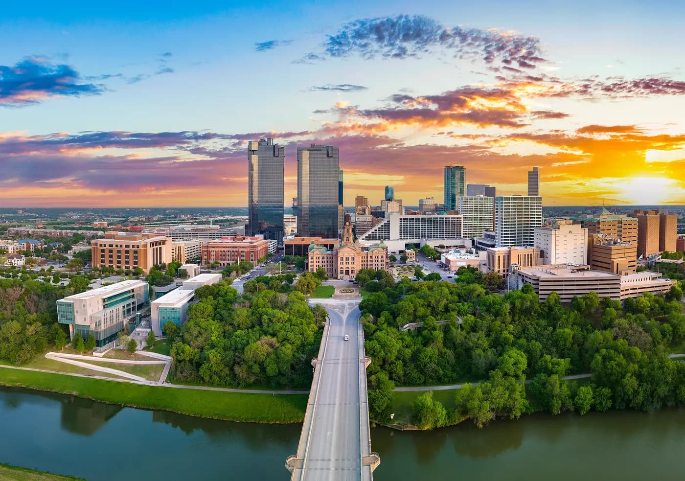 Fort Worth downtown skyline at sunset with Trinity River bridge